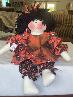 Handmade fabric Halloween rag doll with cat-print clothing. 20”