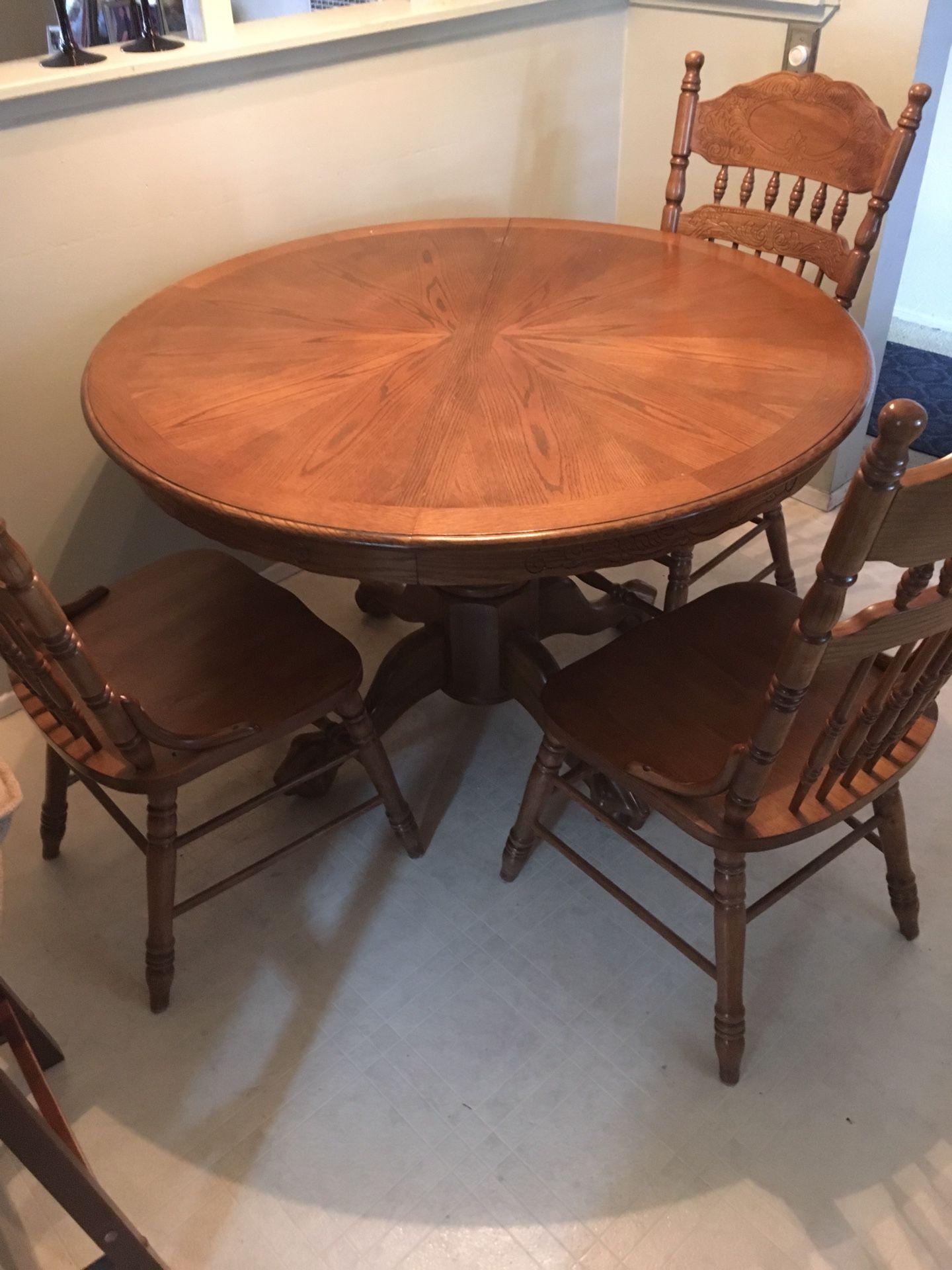 Dining table with four chairs and a leaf