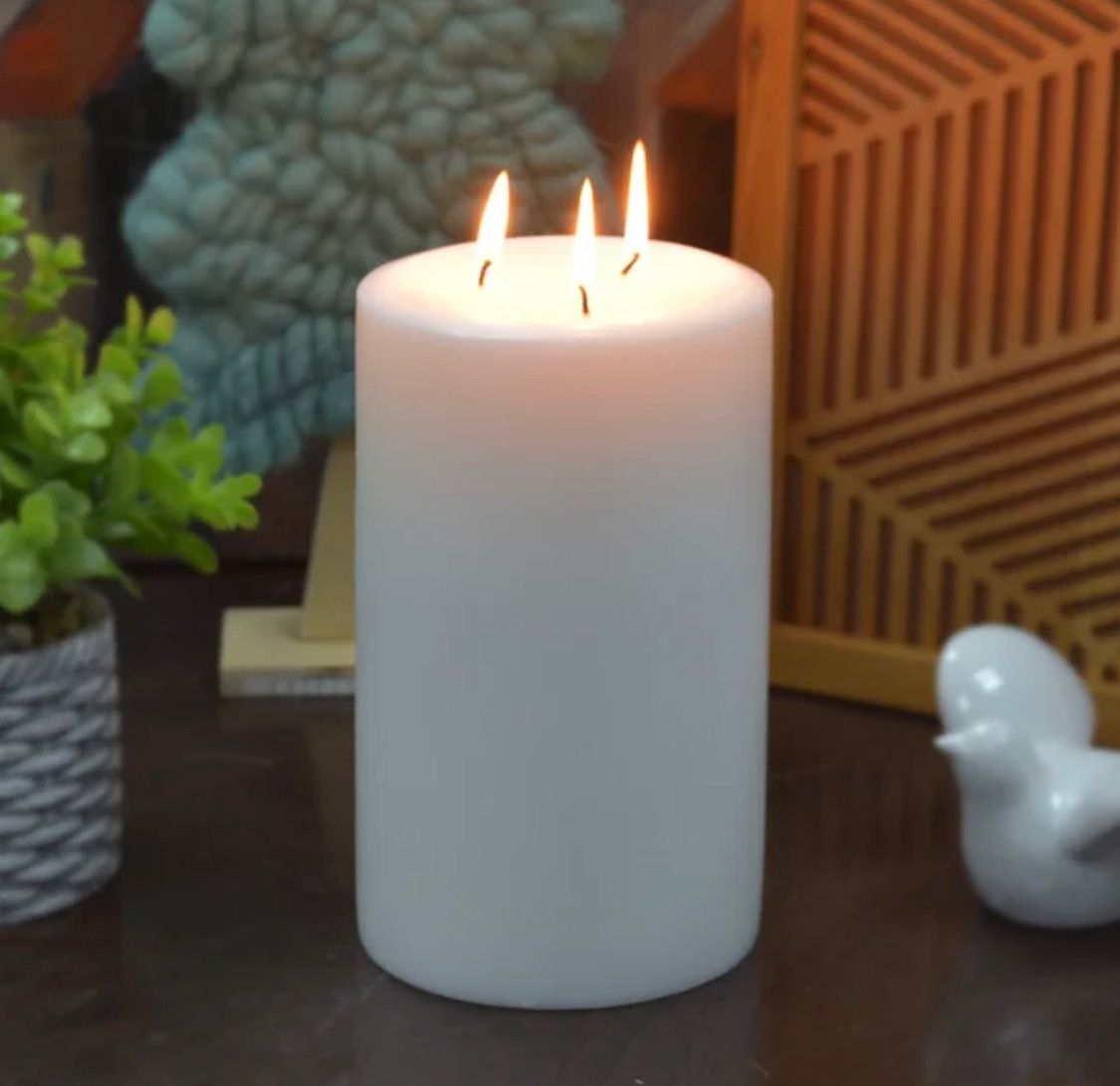 {ONE} Unscented pillar candle. Overall: 5”x8”. Color: white. MSRP: $67. Our price: $44 + Sales tax