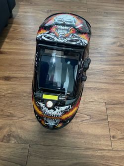 Welding helmet with flashlight