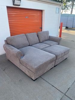 FREE DELIVERY!! New light gray Ashley sectional with ottoman