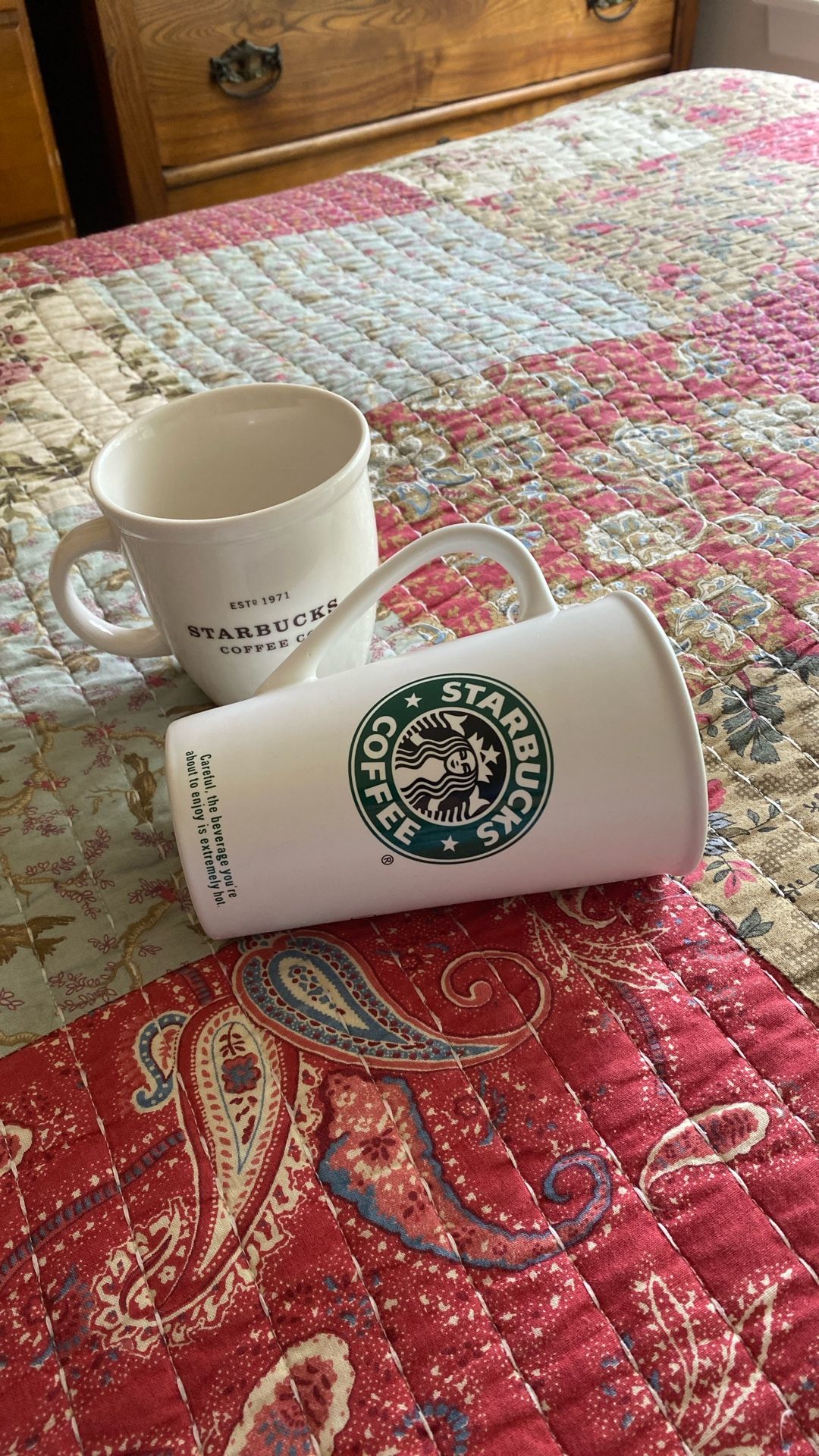 Two Starbucks mugs