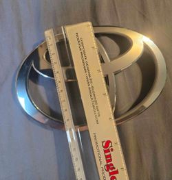 Toyota emblem silver.