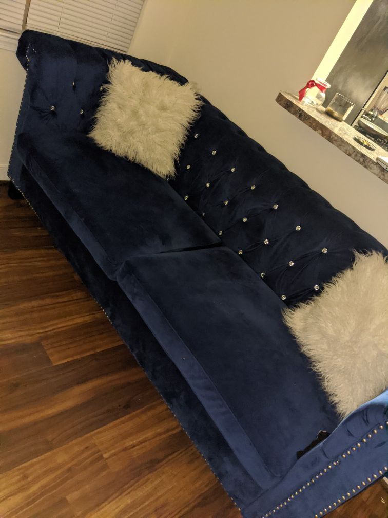 Blue velvet couch white two white fuzzy pillows