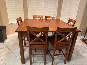 Solid wood bar height table and 6 matching wood chairs