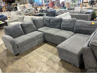 Grey fabric sectional sofa with reversible chaise and storage