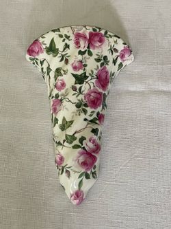 Vintage porcelain wall pocket vase with pink roses and ivy chintz pattern.