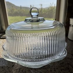 Glass cake stand with dome lid.