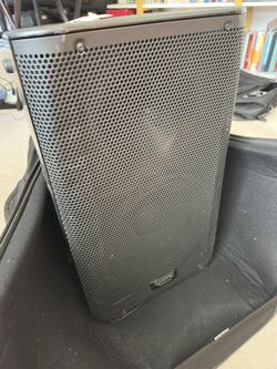 QSC K10 powered speaker with a bag