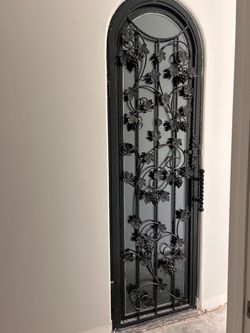 Arched Wrought Iron Glass Door with Grapevine Design