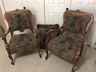 2 beautiful antique wood and upholstered chairs with 2 matching pillows. Front legs have wheels.
