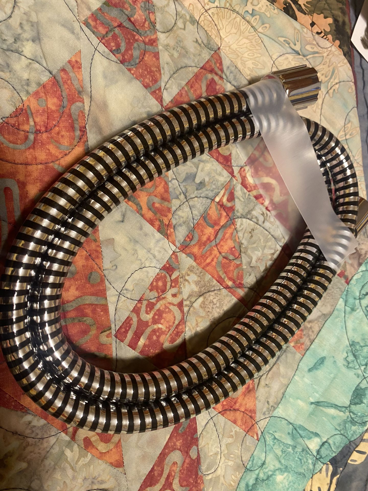 New - never used - Delta 59-Inch Chrome/Black Vinyl Shower Hose