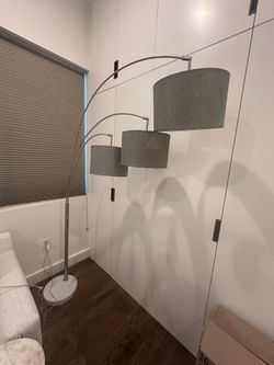 Lamp has 3 grey adjustable shades.