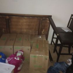 Tall dining room table set wooden and leather chairs and a bench