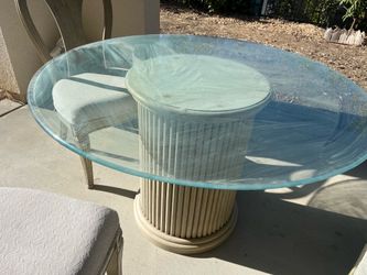 Round glass‑top dining table with 4 chairs
