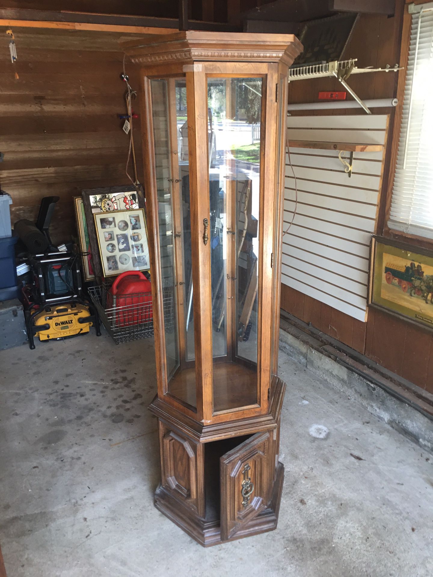 6 Sided Curio Cabinet,6 ft high , 25” Wide 3 glass shelves in top section and wood door on bottom….item Located In Smithtown 