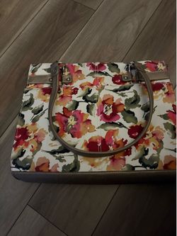 Wilsons Leather handbag features a vintage-inspired floral fabric print with metallic gold leather accents