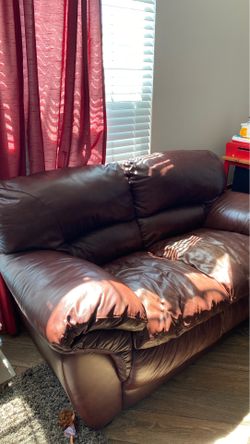 Brown leather love seat and ottoman