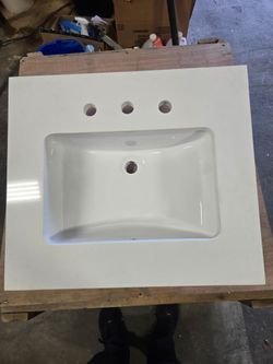 New white Quartz countertop with mounted porcelain sink