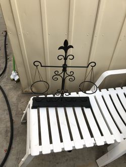 Metal plant holder to hang plants in pots.