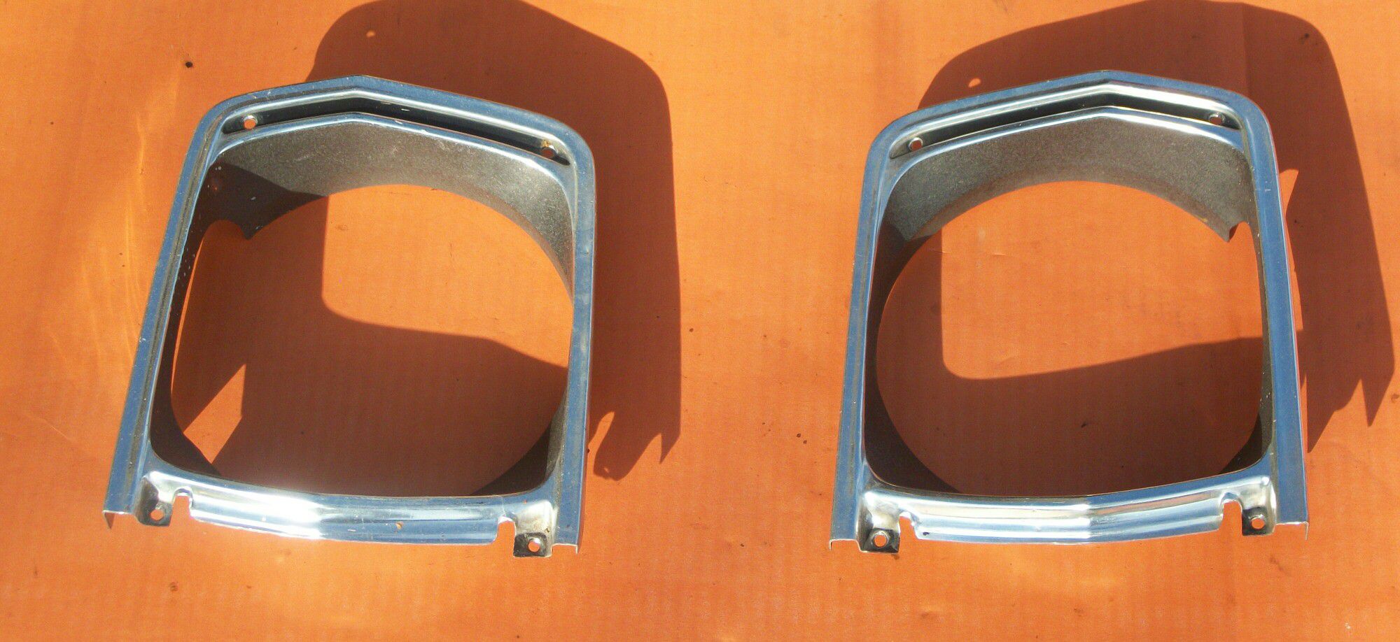 69 PLYMOUTH VALIANT FACTORY (USED) HEADLIGHT BEZELS AND GRILLS