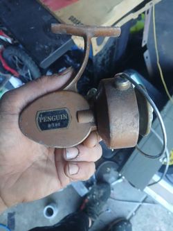 shows a vintage Penguin #102 spinning fishing reel.
Key Details