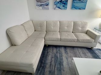 Cream sectional with ottoman