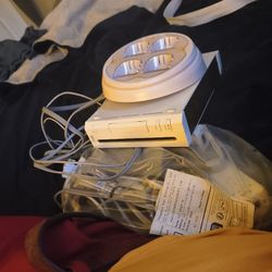 I Have A White  Wii system 3 Control S 2 Num Chuck and a four Port battery Charger ,and  Plug S