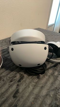 Playstation VR2 with controllers and controller charging stand.