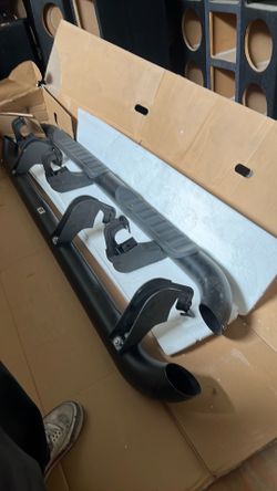 OEM driver's side black round tubular assist step bar designed for 2015–2019 Chevrolet Silverado and GMC Sierra double cab trucks.