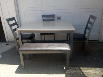 TABLE BENCH AND THREE CHAIRS.