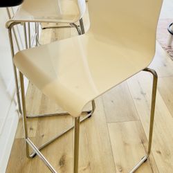 2 stainless steel frame white plastic seat counter stools. 