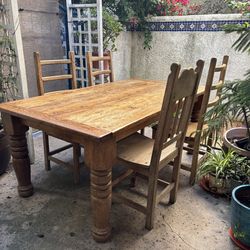 6 foot solid wooden farmhouse dining table with 4 wooden ladder back chairs