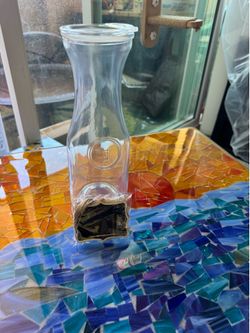 2 sets of 4 glass carafes with  lids