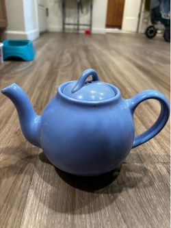 Blue teapot says Lipton tea on bottom