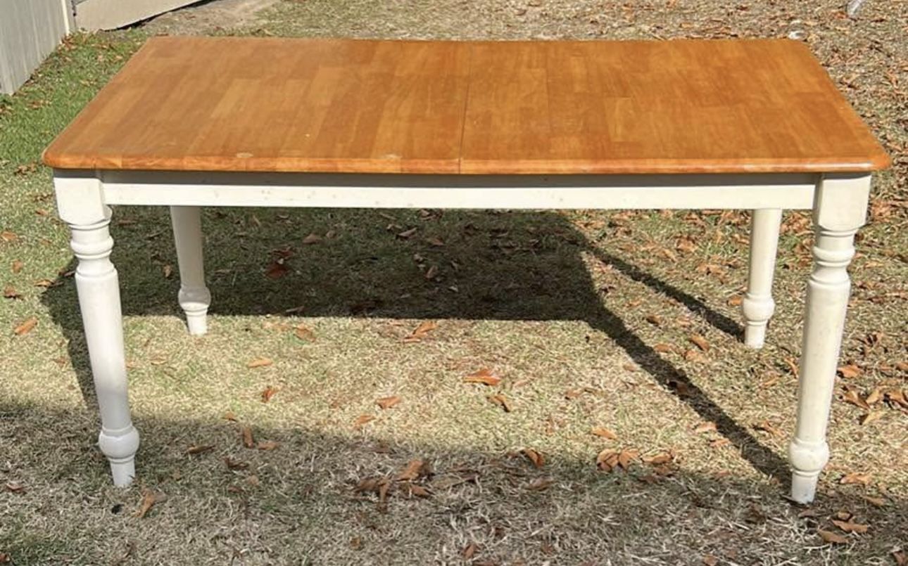 A Wooden & White Table With 4 Chairs 