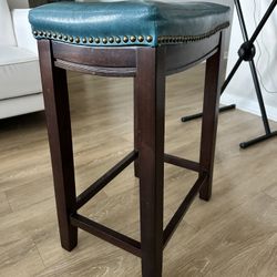 A Set Of 3 Counter-Height Saddle Stools With Soft Cushion 