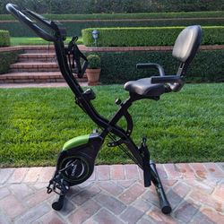 GOOD CONDITION CAROMIX UPRIGHT SEMI-RECUMBENT EXERCISE BIKE WITH ADJUSTABLE EXERCISE BANDS AND COMFORTABLE SEAT