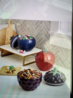 Set of three ceramic containers in the shape of fruit with lids