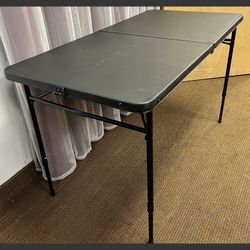48” Black Folding Table with adjustable height legs. 4’ Bifold table
