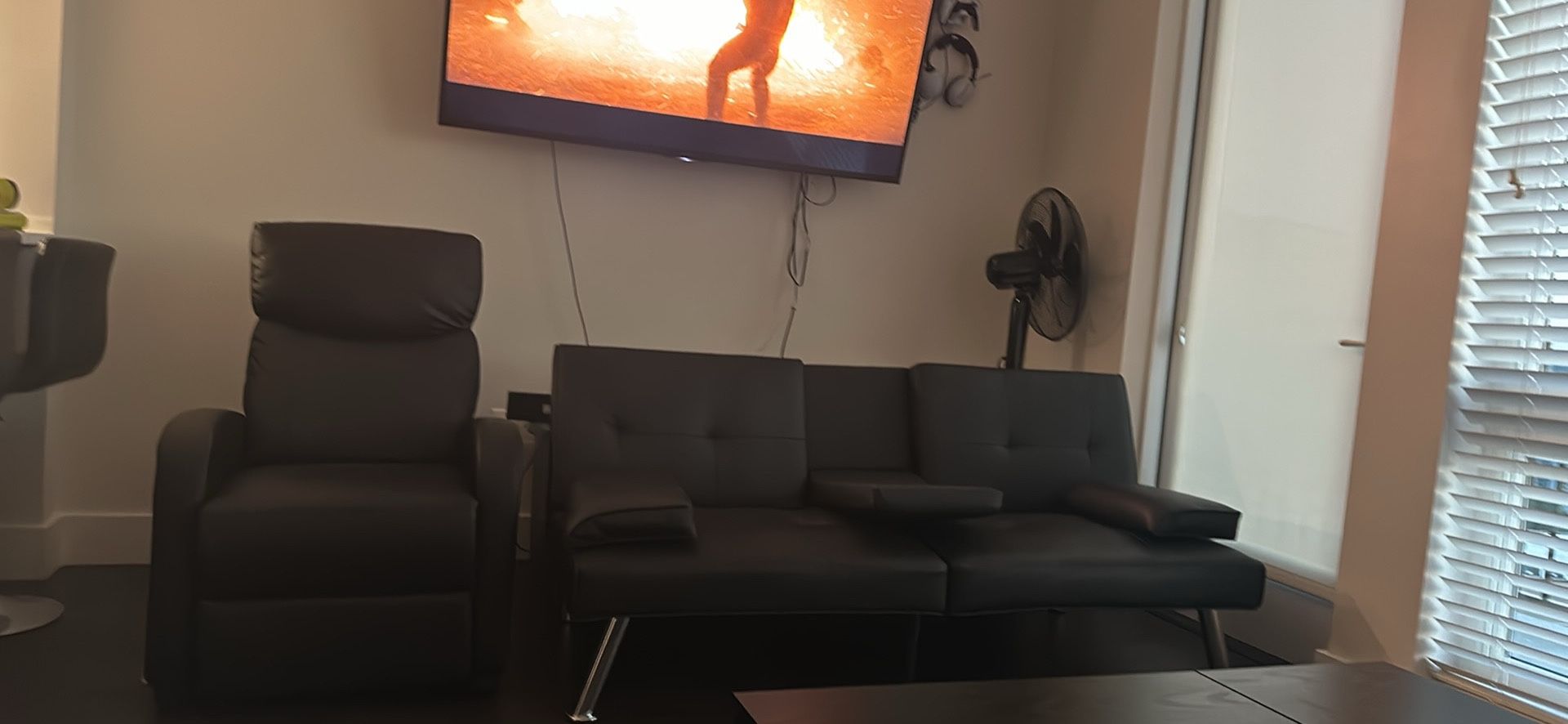 Small black futon sofa and recliner w/ massager