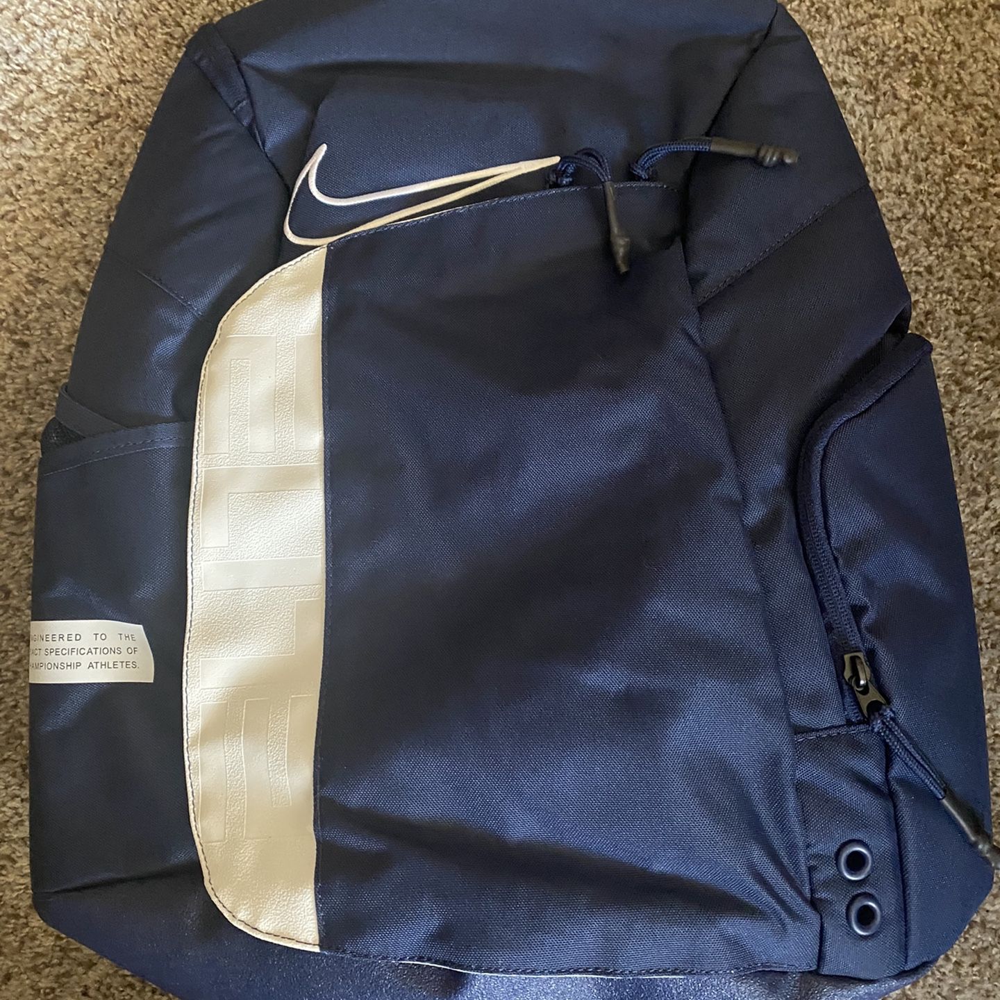 blue and gold nike backpack with Yellow Swoosh  Multi-Compartment School Bag Nike Brasilia JDI Mini Backpack (11L) features a jelly Nike Varsity Elite USA Printed