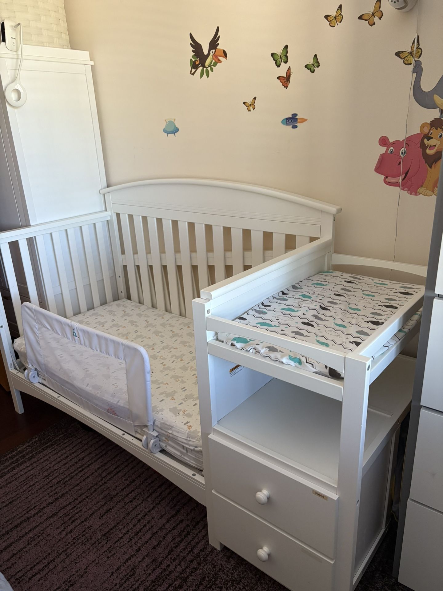 White baby crib with attached storage and mattress included