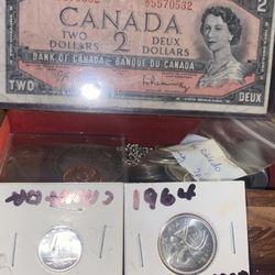 A two dollar Canada bank note with two silver Canadian coins