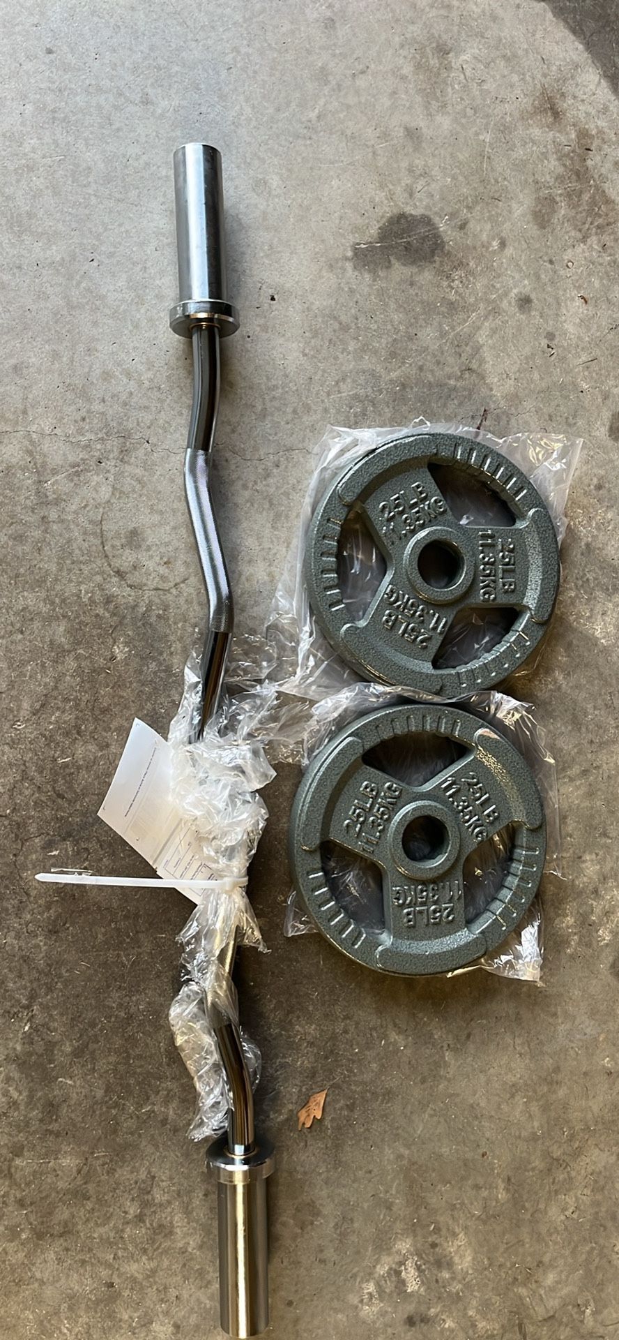 BRAND NEW 2-25 olympic plates and new olympic ez curl bar 