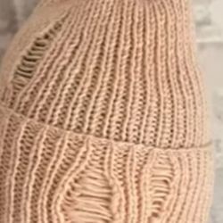 Handmade hat with the effect of torn fabric. 