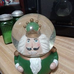 Musical nutcracker snow globe