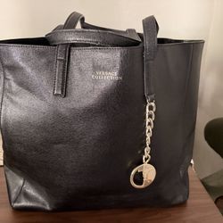 Elevate your style with the Versace Collection Black Tote Bag. This elegant bag features a sleek black design, perfect for any occasion. The gold acce