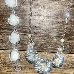 New 2 PCs ETIENNE AIGNER jewelry . One white stoned bracelet & one beautiful silver & yellow flowers located Off lake mead and Simmons area asking $5 