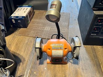 Bench grinder with a light
